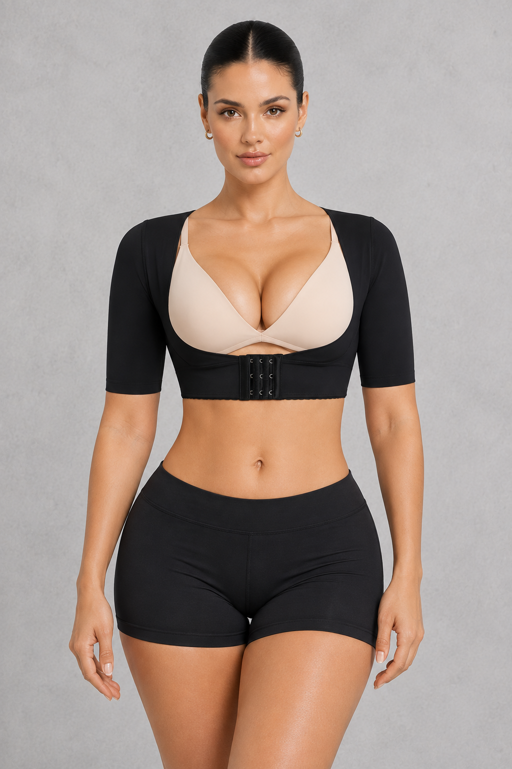 Sculp Upper Arm Shaper Top in Black – front view, worn over a bra