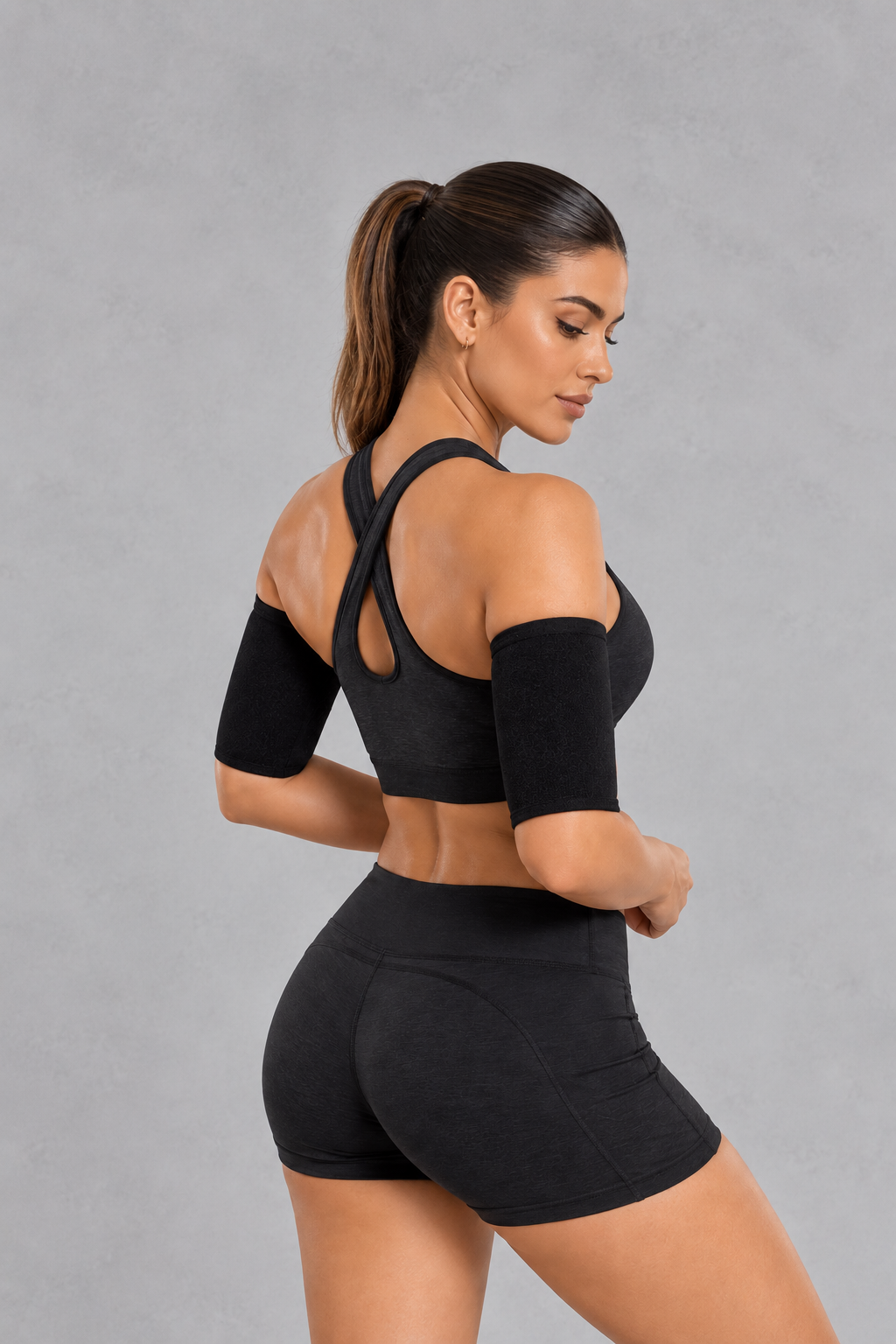 Sculp Sauna Arm Shaper Band in Black – back view, worn on both upper arms