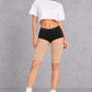 Sculp Thigh Compression Sleeves in Nude – front view, worn on both thighs
