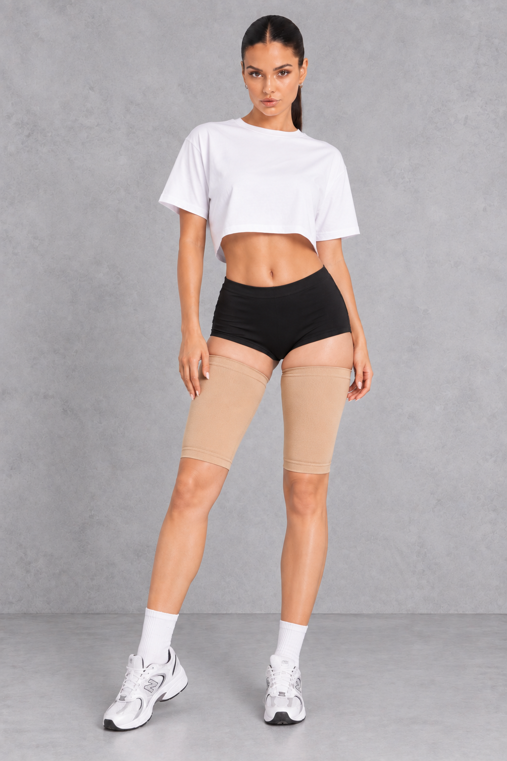Sculp Thigh Compression Sleeves in Nude – front view, worn on both thighs