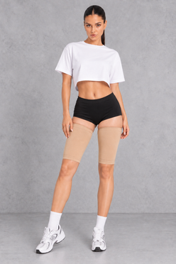 Sculp Thigh Compression Sleeves in Nude – front view, worn on both thighs
