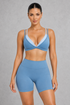 Sculp Low Back Push-Up Sports Bra in Blue – front view, plunge V-neck with light blue contrast trim