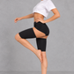 Sculp Thigh Compression Sleeves in Black – side view, one leg raised