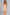 Sculp strapless mid-thigh shapewear bodysuit in nude, side view showing the seamless thigh-length legs