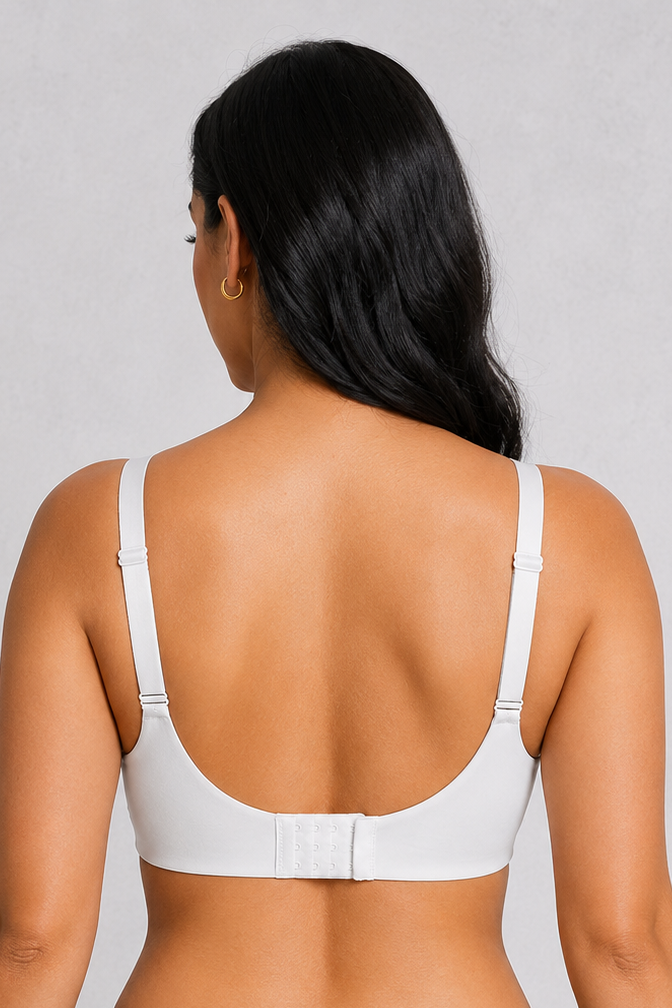 A woman shown from the back wearing a white sports bra and black athletic shorts against a light gray studio background.