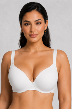 A woman modeling a white seamless underwire bra paired with black athletic shorts against a light gray studio background.