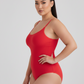 Woman wearing a red swimsuit against a plain background