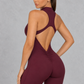 Sculp open back zip gym romper in burgundy, back view with scrunch bum
