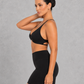Sculp twist front sports bra in black, detail view