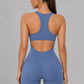 Sculp zip-front racerback gym romper in blue, detail view