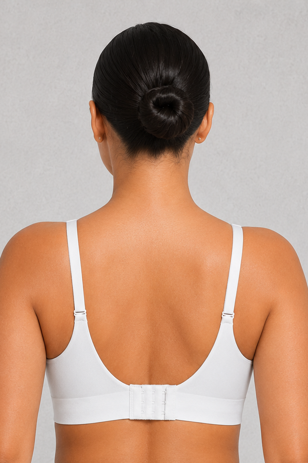 A woman shown from the back wearing a white two-piece swimsuit with a bandeau-style top and high-waisted bottoms against a light gray studio background.