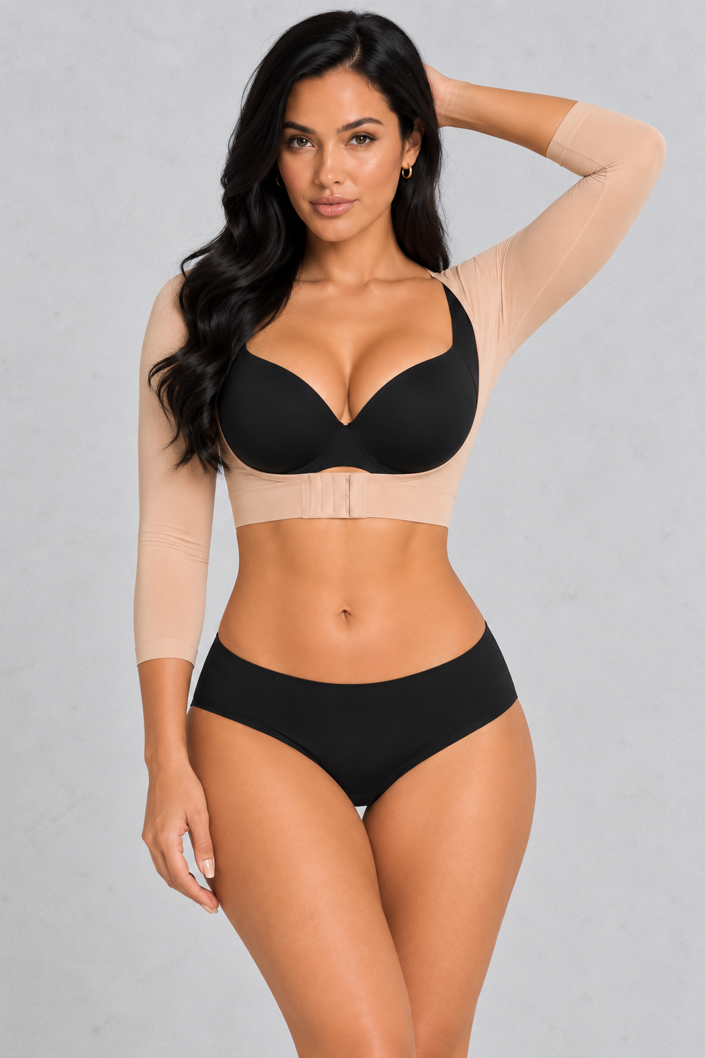 Sculp Arm Shaper Shrug in Beige – front view, worn over a bra